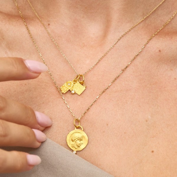 Ana Pendant | 24k gold pendant on a model, styled with other pendants