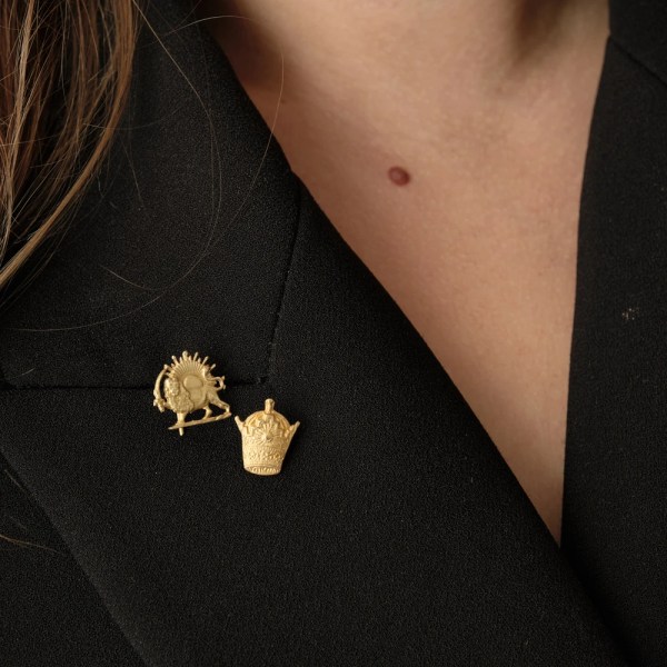 Persia Brooch | 18k gold brooch on a model, styled with Taj Brooch